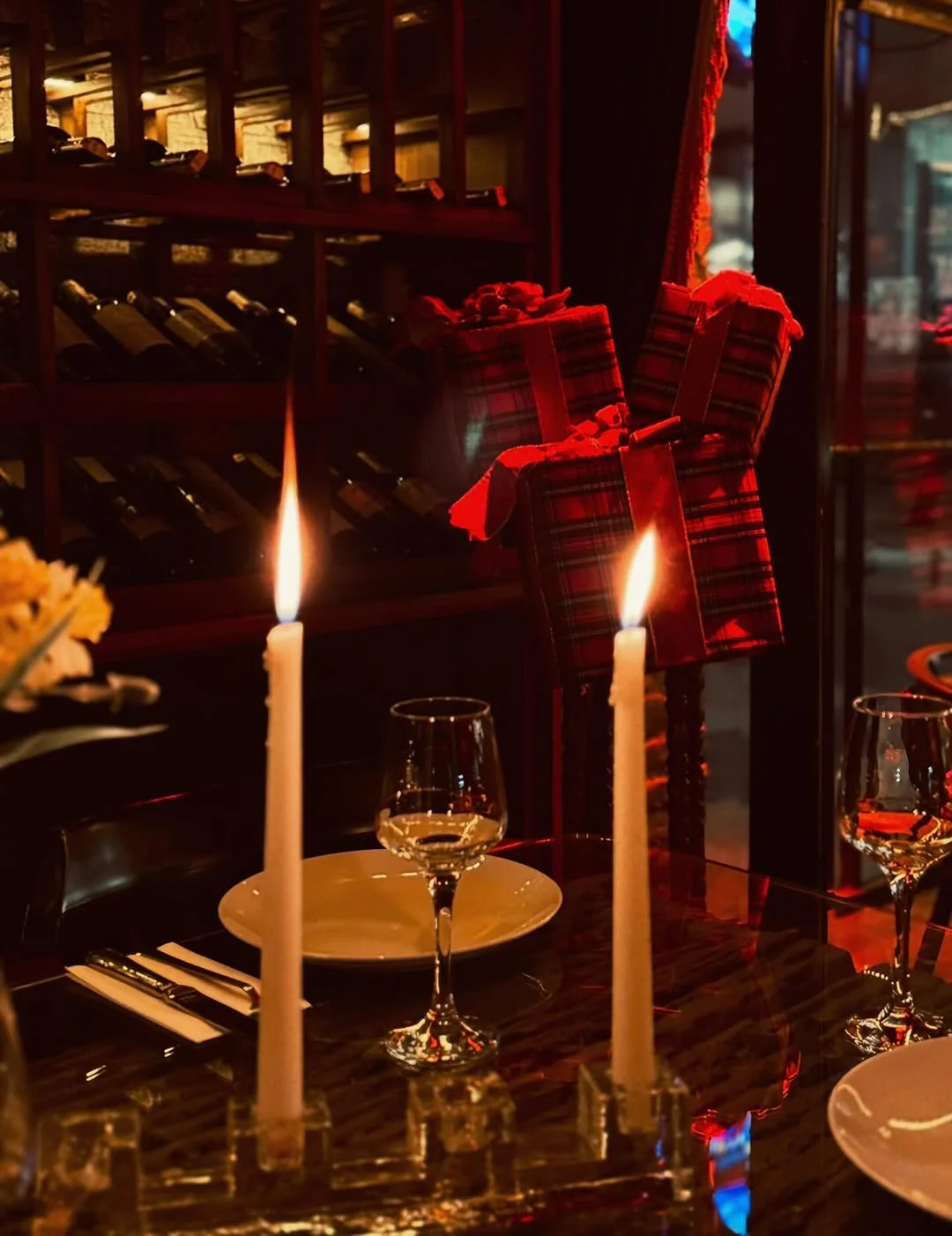 Candlelit table with wine glasses and gift boxes at Hemdem wine cellar Istanbul