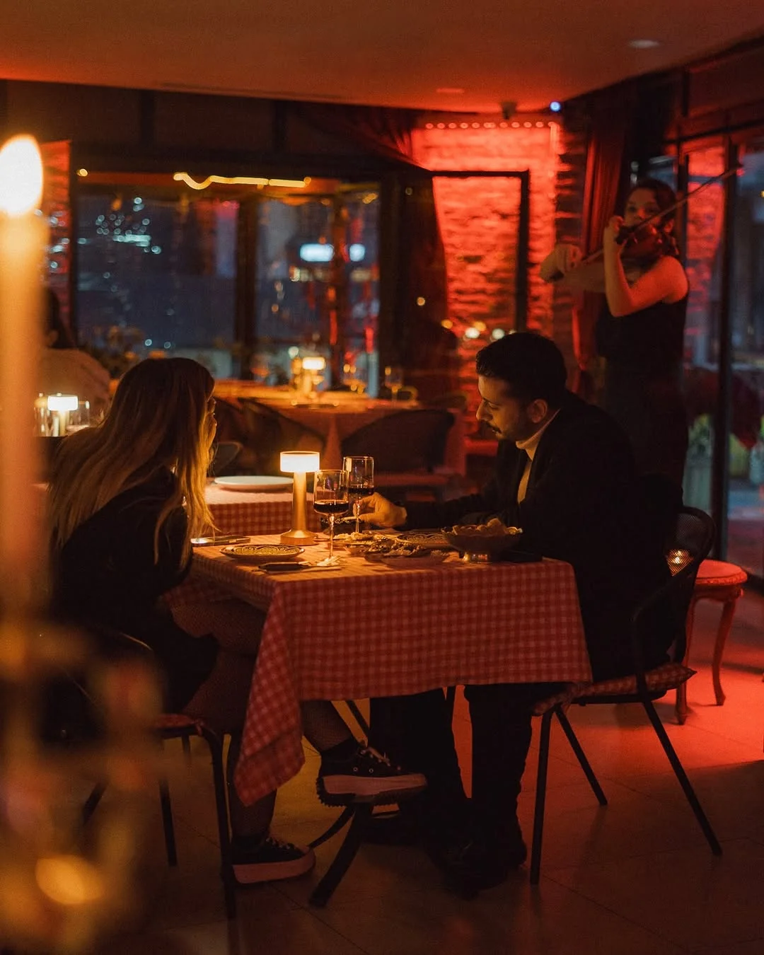 Couple at romantic candlelit dinner with live violin at Hemdem Bomonti Istanbul